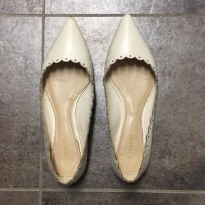 White leather Coach flats with gold stud detailing